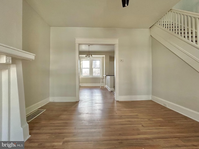 interior space with hardwood / wood-style flooring and a chandelier