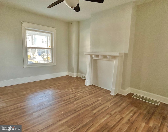 unfurnished living room featuring ceiling fan and light hardwood / wood-style flooring