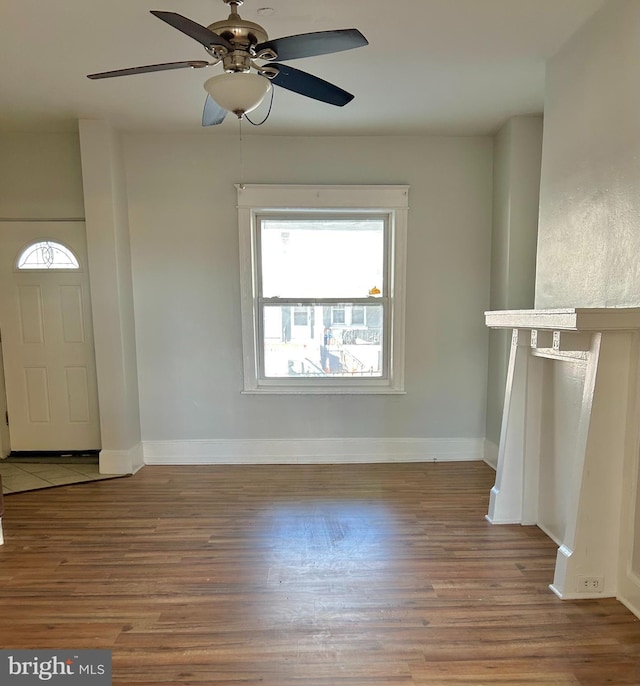 unfurnished living room featuring hardwood / wood-style flooring and ceiling fan