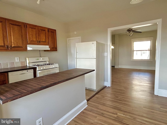 kitchen featuring ceiling fan, wood counters, white appliances, and light wood-type flooring