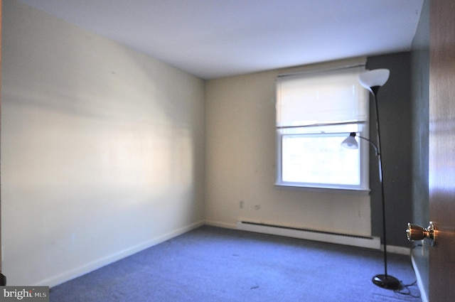 carpeted spare room with baseboard heating