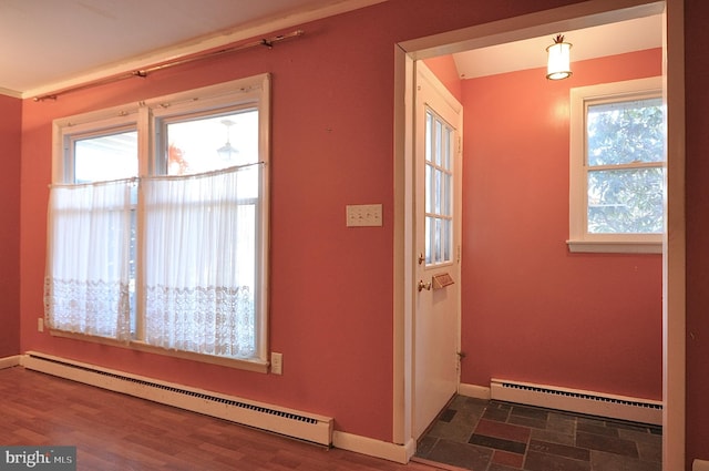 doorway to outside featuring a baseboard heating unit