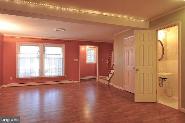 entryway with crown molding, a baseboard radiator, and hardwood / wood-style flooring