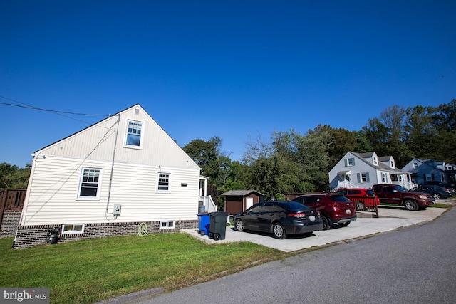 view of side of home with a yard