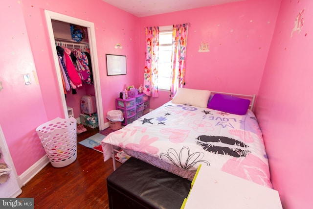 bedroom with hardwood / wood-style floors and a closet