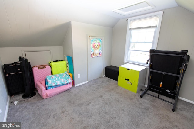 interior space featuring lofted ceiling and light carpet