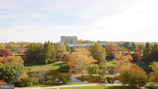 exterior space featuring a lawn and a water view