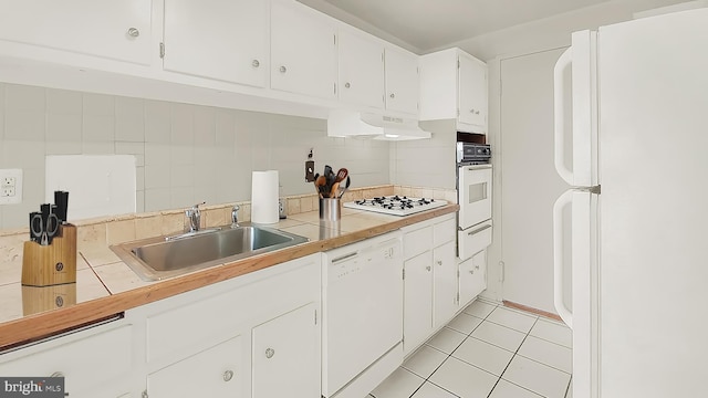 kitchen featuring white cabinetry, sink, white appliances, and decorative backsplash