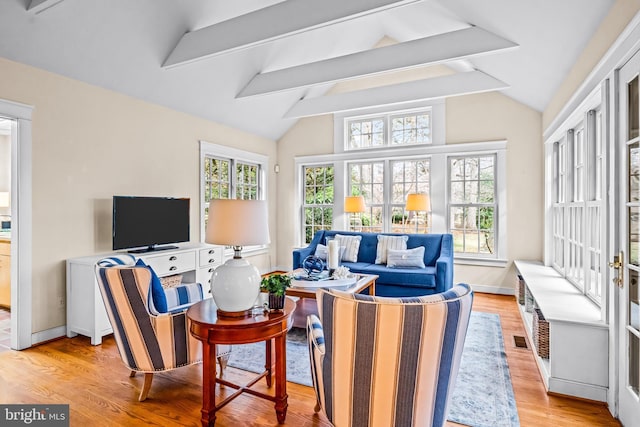 sunroom / solarium with vaulted ceiling with beams