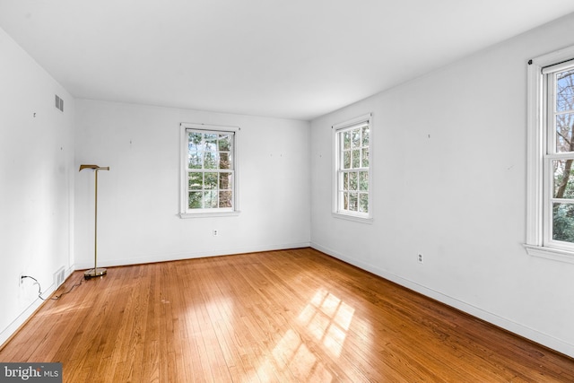 unfurnished room with light hardwood / wood-style floors