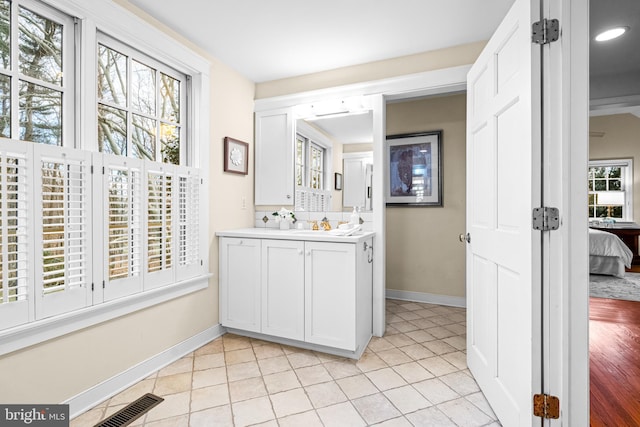 bathroom featuring tile patterned floors, vanity, and plenty of natural light