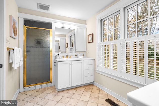 bathroom with a shower with door, vanity, backsplash, and tile patterned floors