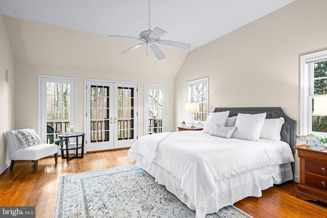 bedroom with vaulted ceiling, hardwood / wood-style flooring, access to exterior, ceiling fan, and french doors