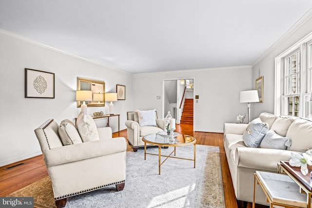 living room featuring wood-type flooring and ornamental molding