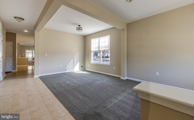 tiled spare room with beam ceiling and plenty of natural light