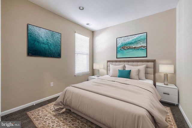 bedroom with dark colored carpet