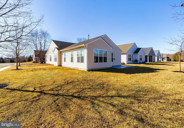 back of property with a patio and a lawn