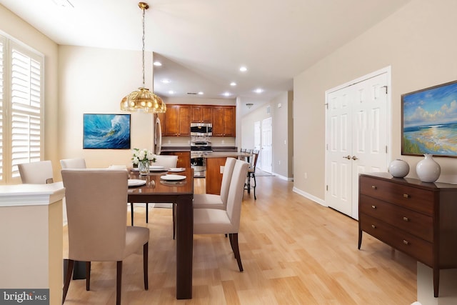 dining area with a healthy amount of sunlight and light hardwood / wood-style floors