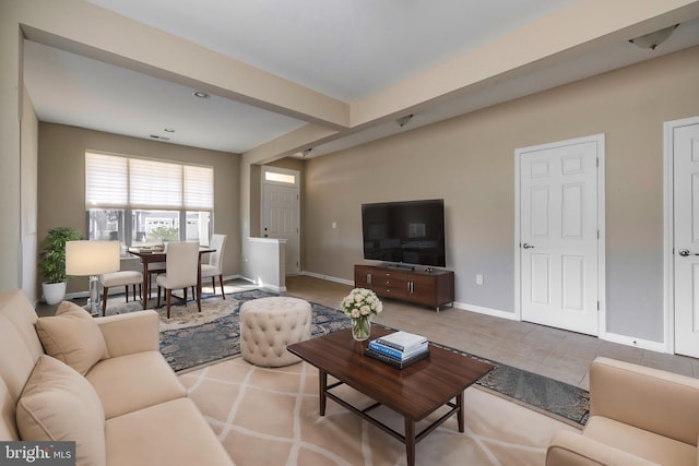 tiled living room with beam ceiling