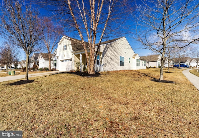 view of home's exterior with a garage and a lawn