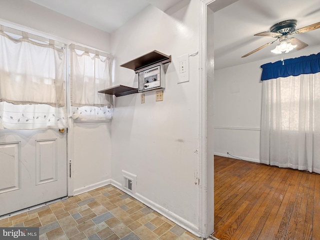 washroom featuring ceiling fan, stone finish floor, visible vents, and baseboards