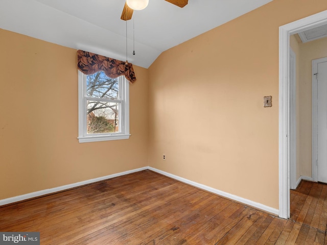 unfurnished dining area featuring lofted ceiling, ceiling fan, hardwood / wood-style flooring, and baseboards