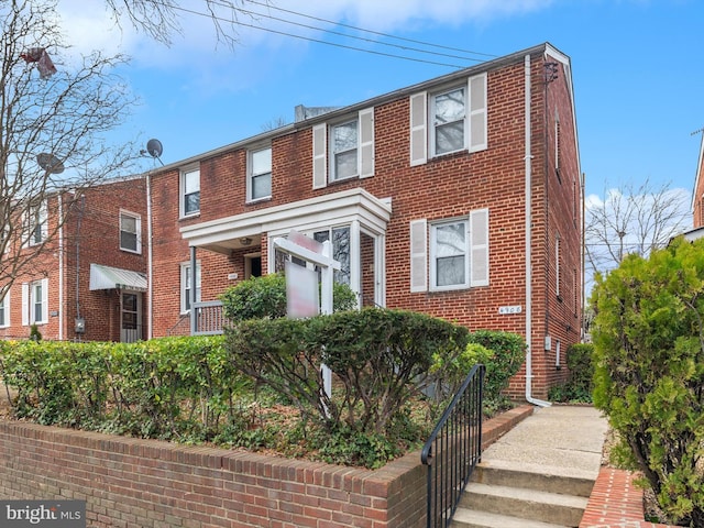 townhome / multi-family property featuring brick siding