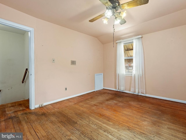 unfurnished room featuring lofted ceiling, baseboards, ceiling fan, and hardwood / wood-style floors