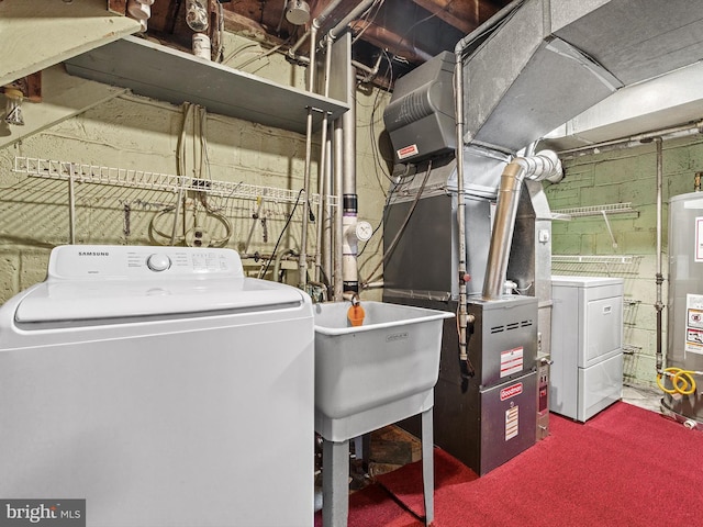 laundry room with gas water heater, heating unit, a sink, laundry area, and independent washer and dryer