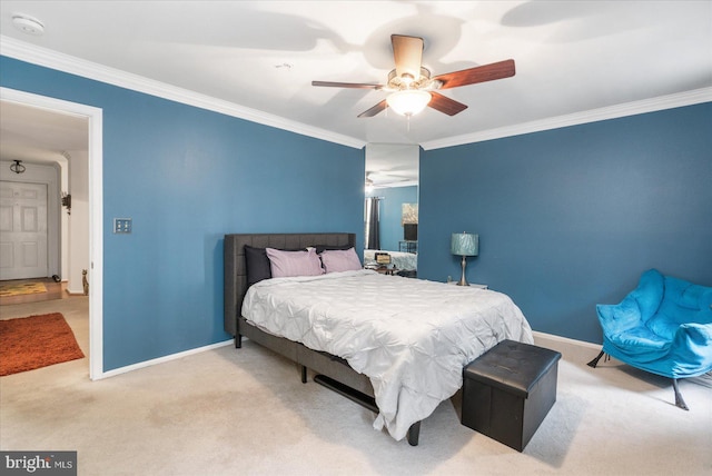 carpeted bedroom with ceiling fan and ornamental molding