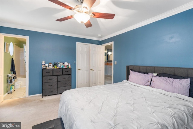 carpeted bedroom featuring crown molding, ceiling fan, and ensuite bath