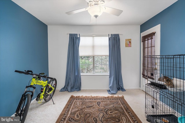 misc room featuring light colored carpet and ceiling fan