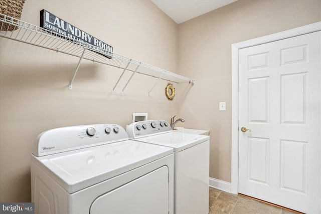 clothes washing area featuring washer and dryer and sink