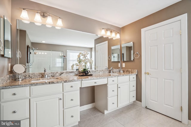 bathroom featuring tile patterned flooring, vanity, and a shower with shower door