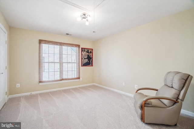 sitting room featuring light carpet