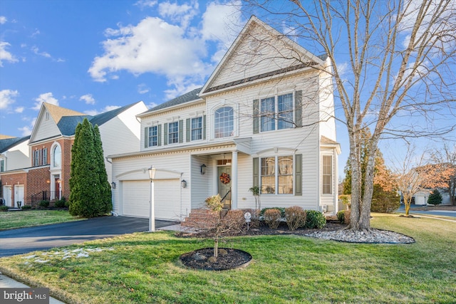 front of property with a garage and a front yard