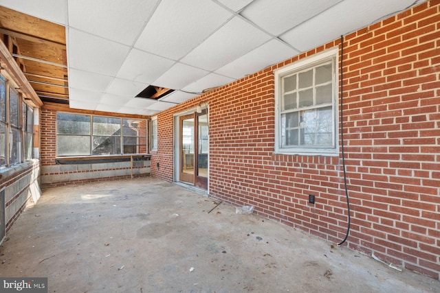 unfurnished sunroom with a drop ceiling