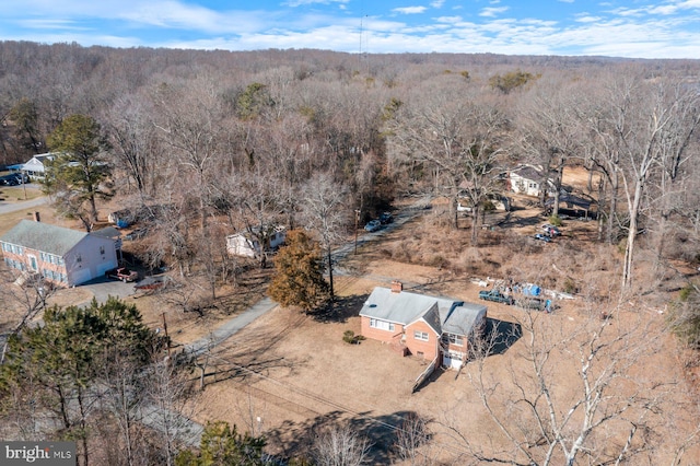 birds eye view of property with a forest view