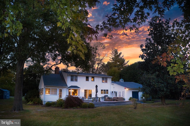 colonial-style house featuring a lawn