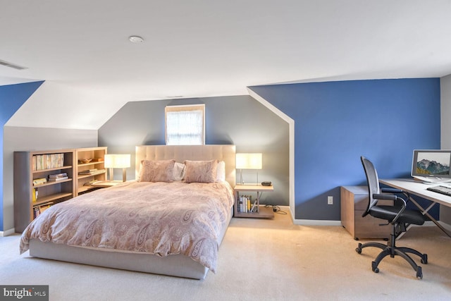 carpeted bedroom with lofted ceiling