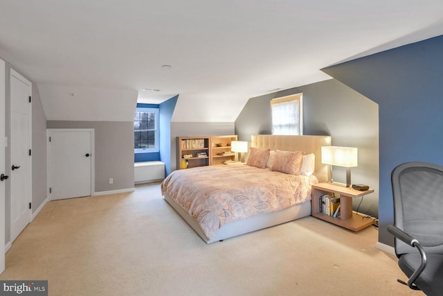 carpeted bedroom with multiple windows and lofted ceiling