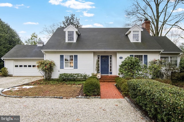 new england style home featuring a garage