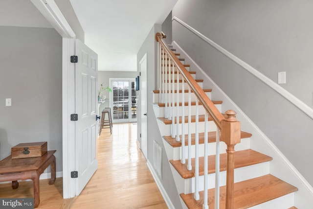 stairs featuring hardwood / wood-style flooring