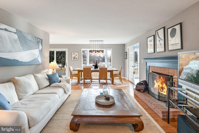 living room with a fireplace and wood-type flooring