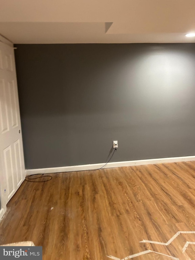 unfurnished room with hardwood / wood-style flooring