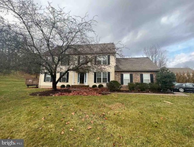 colonial-style house with a front lawn