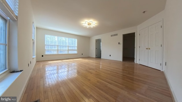 interior space featuring light wood finished floors, visible vents, and baseboards