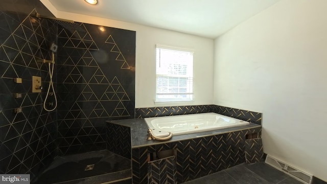 full bath featuring tile patterned flooring, a garden tub, visible vents, and tiled shower