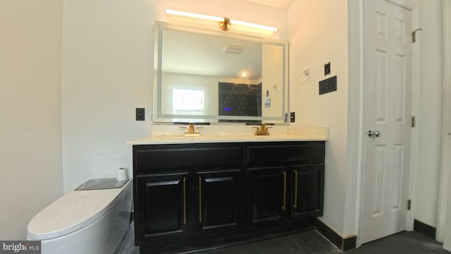 bathroom featuring toilet, double vanity, a sink, and visible vents