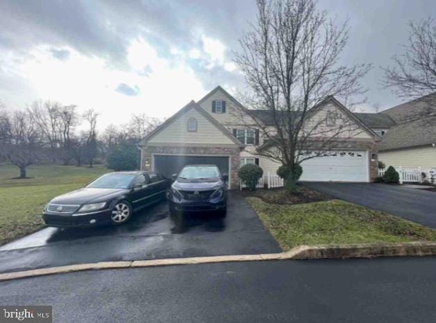 view of front of home with driveway and an attached garage